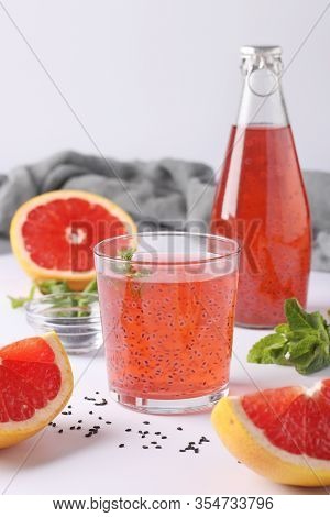 Healthy Drink Grapefruit With Basil Seeds Or Falooda Seeds Or Tukmaria In A Bottle And Glass On A Wh