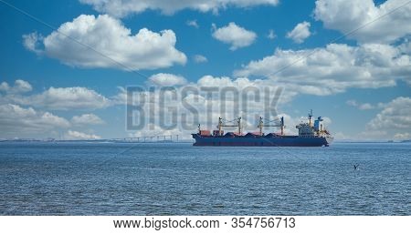 A Dredging Ship Anchored In A Harbor And Working On The Shipping Lane