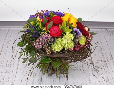 Flower Arrangement With Roses, Lilac And Anemones On Light Wooden Floor