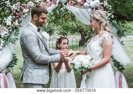 The Bride And Groom Exchange Vows And Wedding Rings At The Wedding Ceremony. Selective Focus. Film G