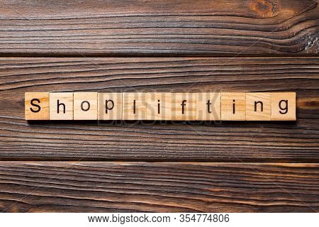 Shoplifting Word Written On Wood Block. Shoplifting Text On Wooden Table For Your Desing, Top View C