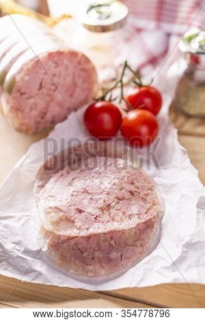 Sliced Headcheese On A Paper On A Wooden Worktop, Top View. Brawn. Pork Cold Cuts.