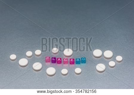 Placebo Pill. White Pills And Word Placebo On Silver Grey Background. Placebo Effect, Fake Medical T