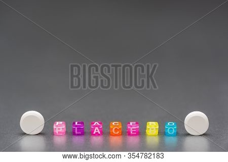 Placebo Pill. White Pills And Word Placebo On Silver Grey Background. Placebo Effect, Fake Medical T