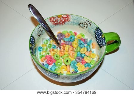 Close Up Of A Bowl Full Of Fruit Flavored Loops Of Sugar Ready To Eat Breakfast Cereal With A Spoon 