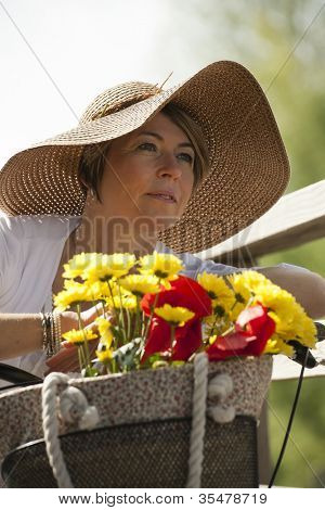 Woman on her bike with colorful flowers