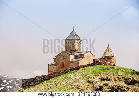 Stephantsminda, Georgia. Gergeti Trinity Church Or Tsminda Sameba - Holy Trinity Church Near Village