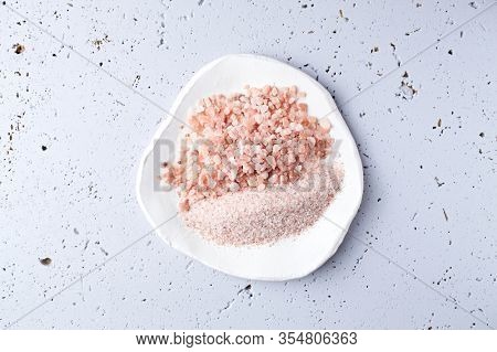 Pink Himalaya Salt on a white ceramic plate. Top view