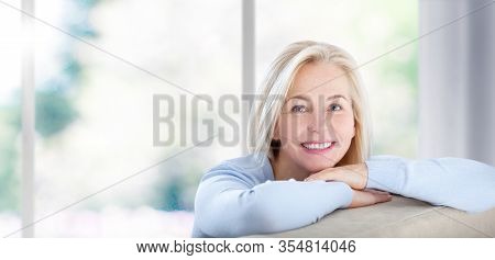 Beautiful Business Woman Smiling Friendly And Looking In Camera Near The Window In Office. Happy Wom
