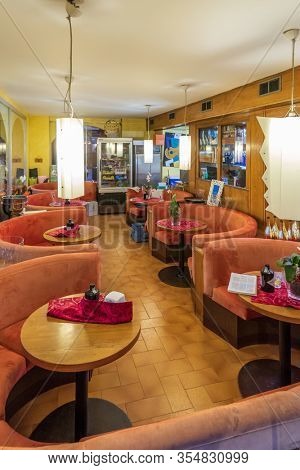 MALCESINE, ITALY, JUNE 20, 2017: INTERIOURS OF STREET RESTAURANTS AT NIGHT IN THE CENTRE OF MALCESINE.