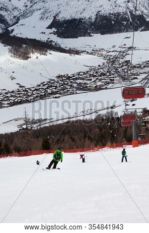 Chair-lift, Snowy Ski Slope With Snowboarders And Skiers In High Mountains At Winter. Ski Area Motto