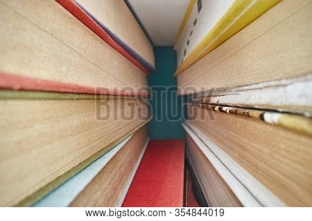 Pile of books from wierd macro perspective from in between them