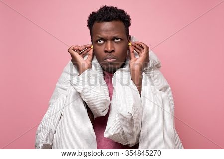 African American Youngman Inserting Ear Plugs Happy With Solution Of Neighbours