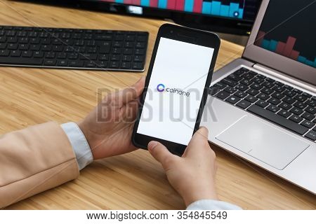 Coinone Cryptocurrency Exchange Market. Female Trader Hands Holding The Smartphone Using Application