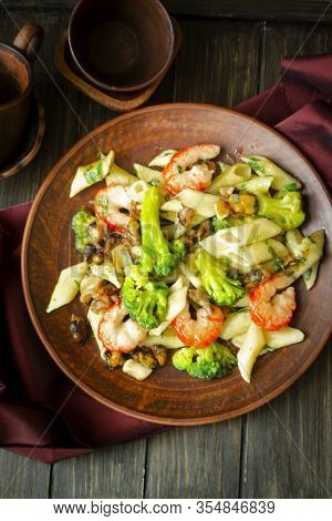 Fresh Salad Plate With Shrimp, Penna Pasta, Avocado And Arugula On Wooden Background Flat Lay. Healt