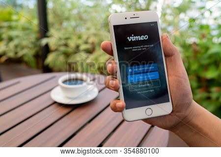 Chiang Mai, Thailand - Feb.17,2020: Man Holding Apple Iphone 8 Plus With Vimeo On Screen. Vimeo Is A