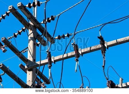 High Voltage Electric Pole And Transmission Lines With Clear Blue Sky. Electricity Pylon. Power And 
