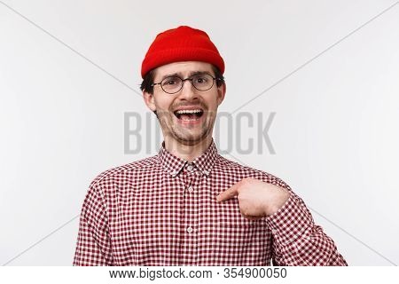 Close-up Portrait Boastful Funny Bearded Young Man In Red Beanie And Glasses, Pointing At Himself As