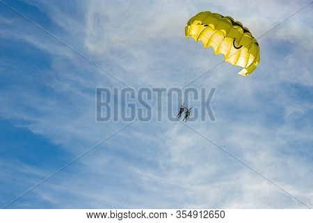 Yellow Parasail Wing Flying Over Turquoise Water
