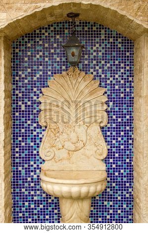 Antique Washbasin Made In A Modern Form Using Modern Building Materials. With A Blue Mosaic In The B