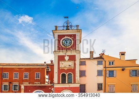 A Red Clock Tower At The  Marsala Tita Square In Rovinj Town, Croatia, Europe.