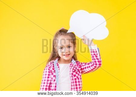 Pretty Fair Haired Girl In Pink Checkered Shirt Is Holding White Paper Decorative Thinking Cloud. Cu