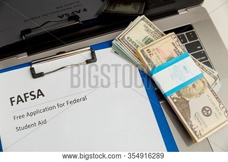 Fafsa. Student Aid Statement Form And Money On The Tablet.