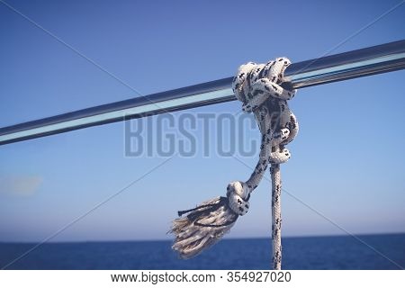 Marine Knot Detail Stainless Steel Boat Railing. Marine Fender Knot Around Boat Lee. Close-up Nautic