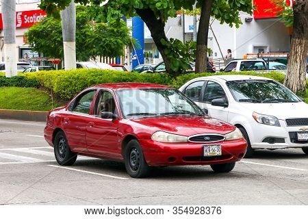 Acapulco, Mexico - May 30, 2017: Red Sedan Ford Mondeo In The City Street.