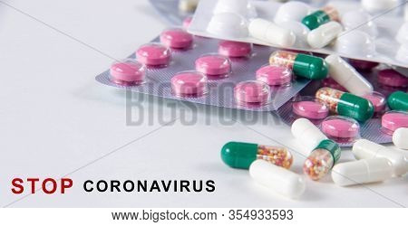 Coronavirus Phrase Text On A White Background With Medicines And Pills. The Concept Of The New 2019 