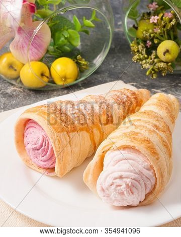 A Tube Of Pink Custard On A White Plate