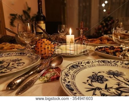 Lithuanian Christmas Eve Table With Christmas Wafers, Candle And Various Dishes