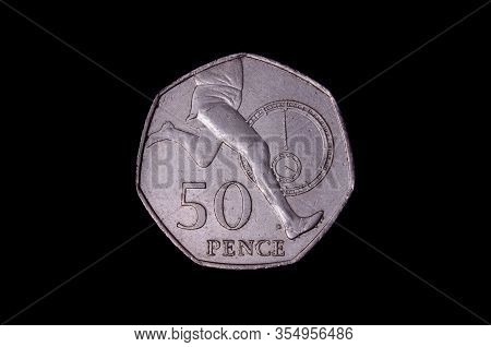 L.50 italian coin isolated on the dark background