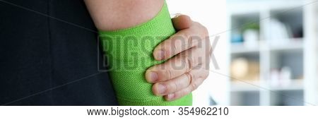 Close-up Of Male Person Wearing Green Swathe Wrap. Sportsman With Damaged Hand In Elastic Bandage. M
