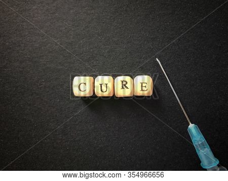 Health Care And Medical Concept. Cure Written On Wooden Blocks. Blurred Styled Background.