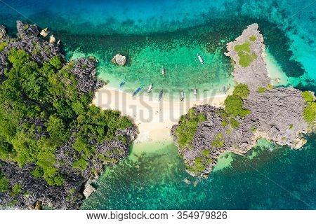 Top View Of Small Tropical Island With White Sandy Beach And Blue Transparent Water. Lahos Island, C