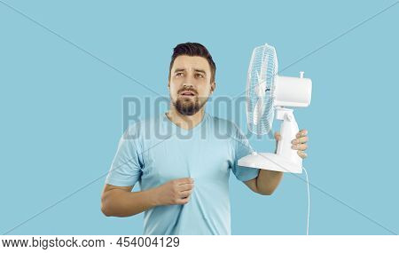 Man Suffers From Summer Heat, Feels Extremely Hot, Uses Electric Fan But Still Keeps Sweating