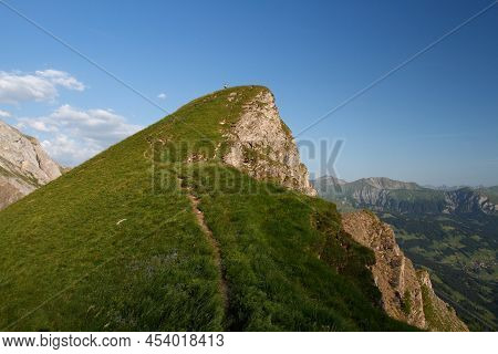 Female Hiker Far Away On The Top Of A Mountain In Switzerland