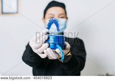 A Dentist Holding Retainers, Female Dentist Holding Dental Retainers, Portrait Of A Female Dentist H