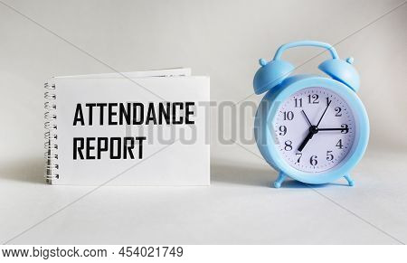 On A White Background Is A Notebook With The Text Attendance Report. Business Concept. Banner