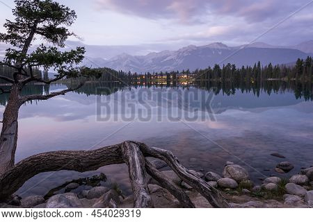 Colourful Sunset On Mirrorlike Lake With Mountains In Backdrop , Wide, Jasper National Park, Canada.