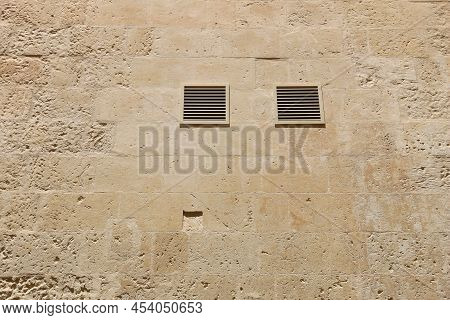 Italian Town Lecce In Puglia Region. Old Town Stone Wall With Contemporary Plastic Air Vents.