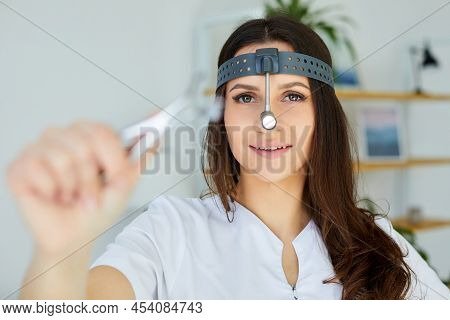 Instruments Ent Doctor Close-up With Hand. Therapist. Female Ent Doctor Holding A Tool. Nasal Specul
