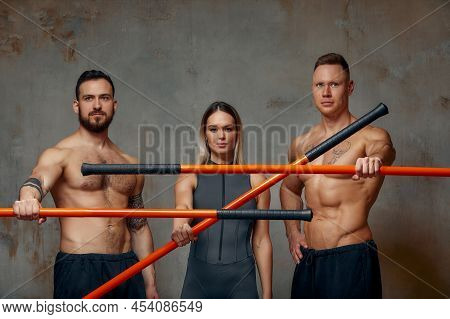 Three Martial Arts Masters, Karate, Taekwondo Practice. Concrete Gray Background. Sports Banner