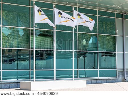 Samara, Russia - May 3, 2022: Flags Of Rosneft Oil Company Against The Office Building. Rosneft Is O