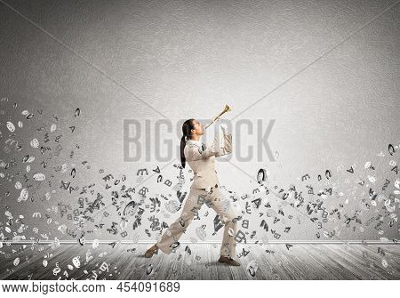 Woman Playing Trumpet Brass Instrument And Flying Various Letters Around. Young Businesswoman In Whi
