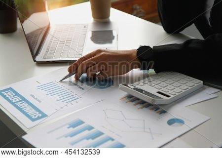 Financial Advisor Calculating Numbers Datasheets Graphs Charts Reports Marketing Research Developmen