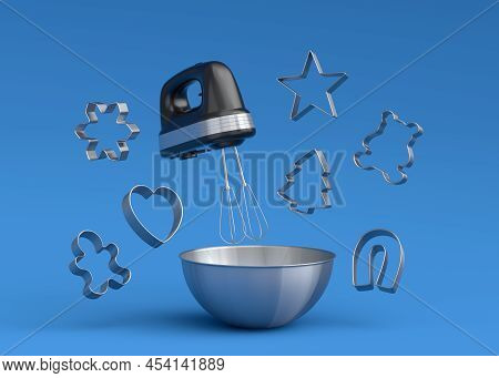 Metal Bowl With Electric Mixer And Cookie Cutters On Blue Background