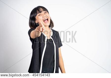 Woman With Finger Pointing At Frong And Laughing At Something
