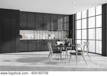 Corner View On Dark Kitchen Room Interior With Dining Table With Chairs, Panoramic Window, Cupboard,